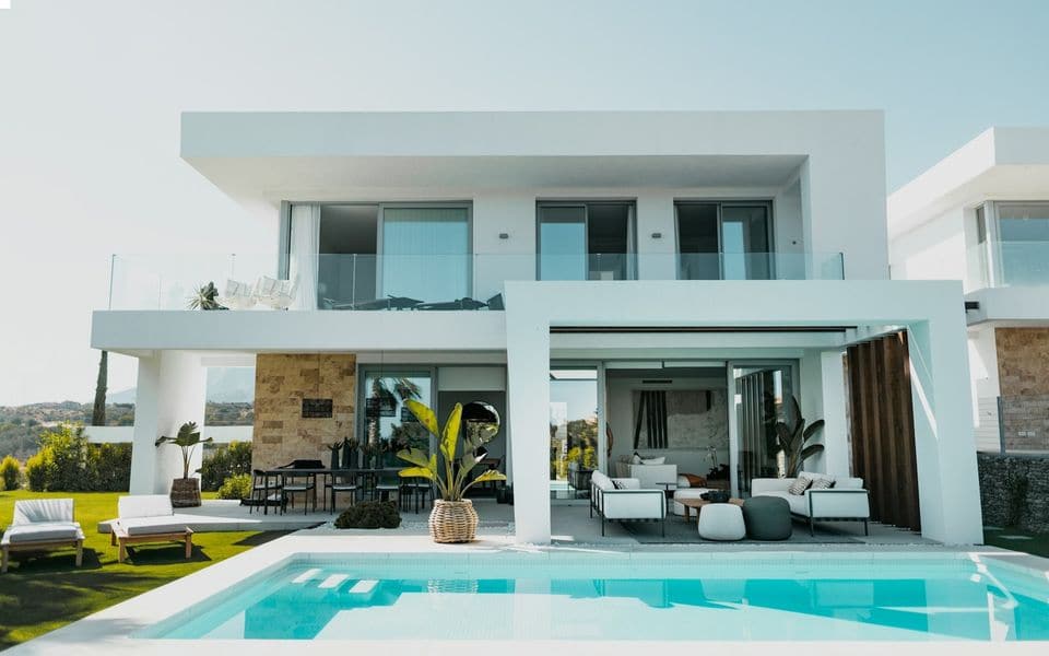 Modern white villa with a swimming pool in daylight
