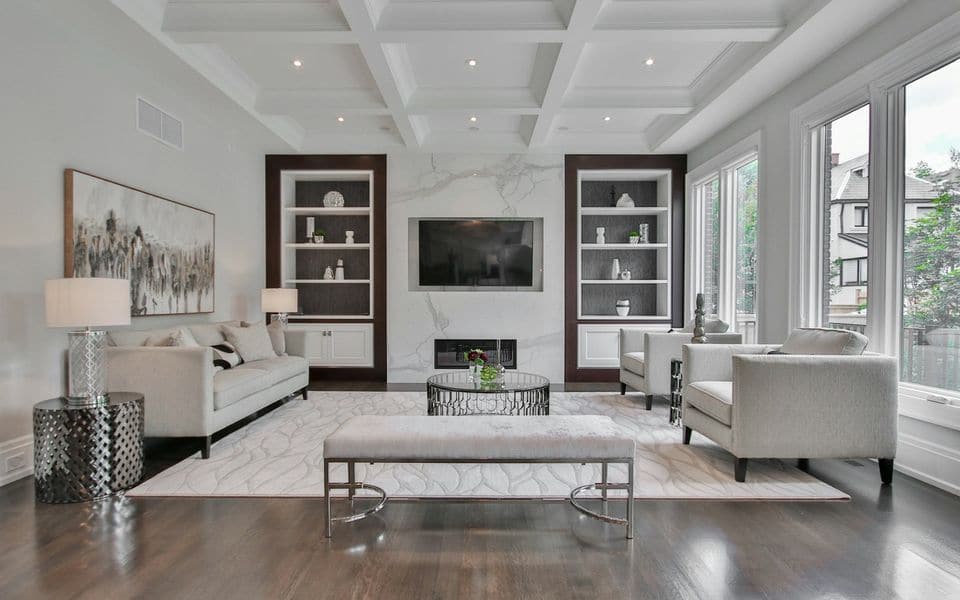 Contemporary living room with a coffered ceiling and a marble feature wall
